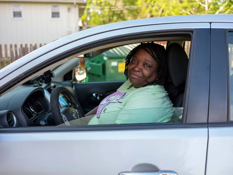 Jackie in the driver's seat of her car.