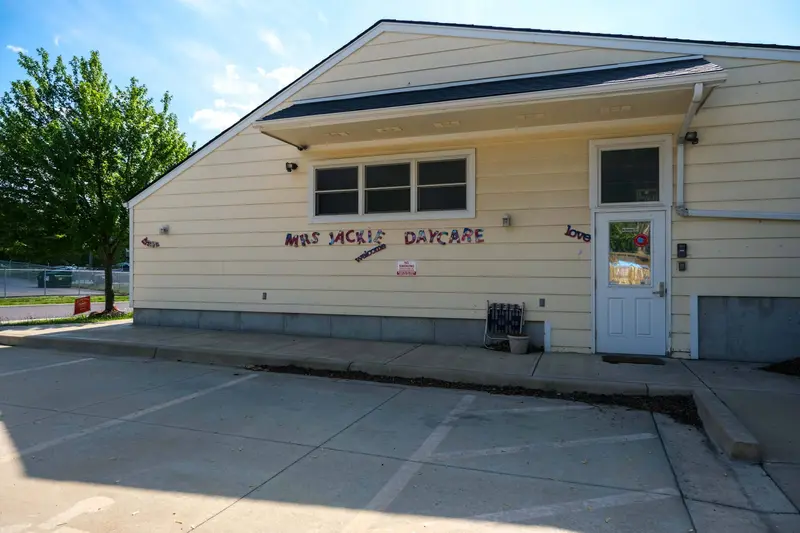 Exterior photo of Damion’s Place, a yellow building with a window and a sign saying Damion's Place.