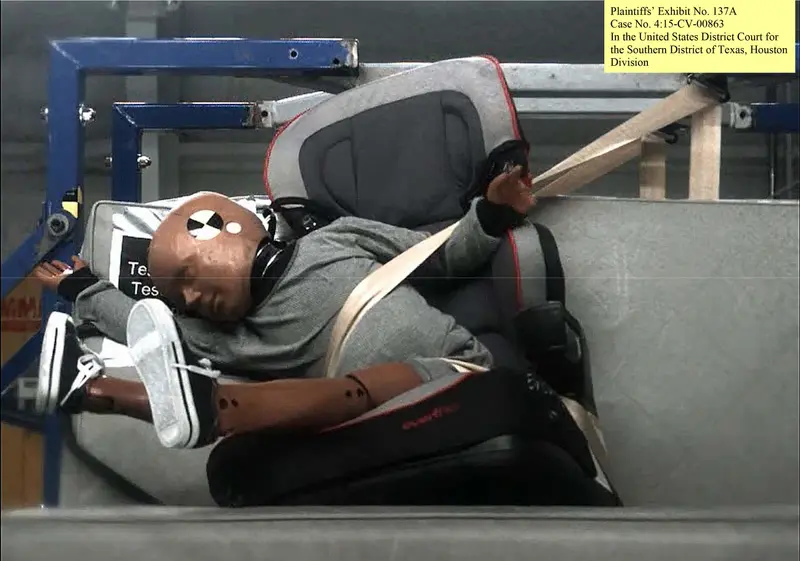 A child-sized dummy in a booster seat lurches hard to the left.