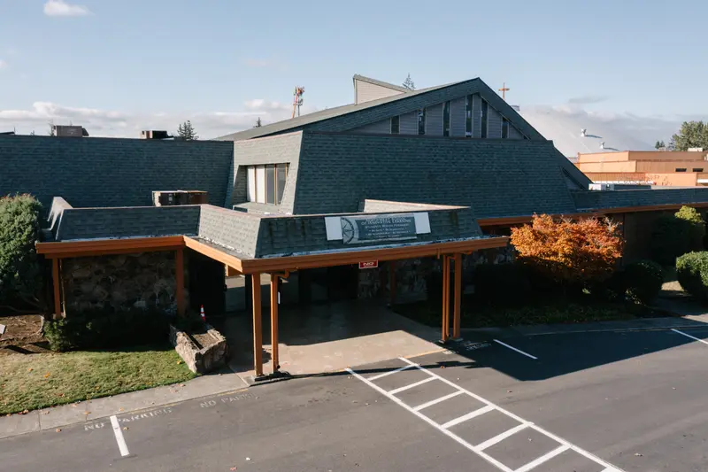 A large shingled building with a Northwest School of Innovative Learning banner.