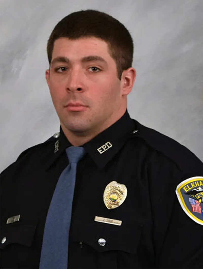 A young man with short brown hair in an Elkhart police uniform.