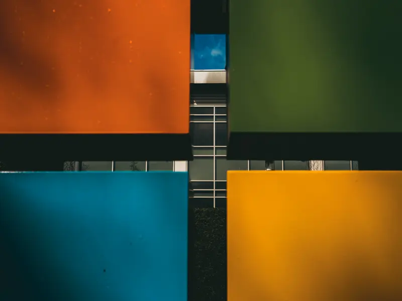 A building seen behind four large rectangles, one red, one green, one blue and one yellow, comprising the Microsoft logo. A building seen behind four large rectangles, one red, one green, one blue and one yellow, comprising the Microsoft logo.