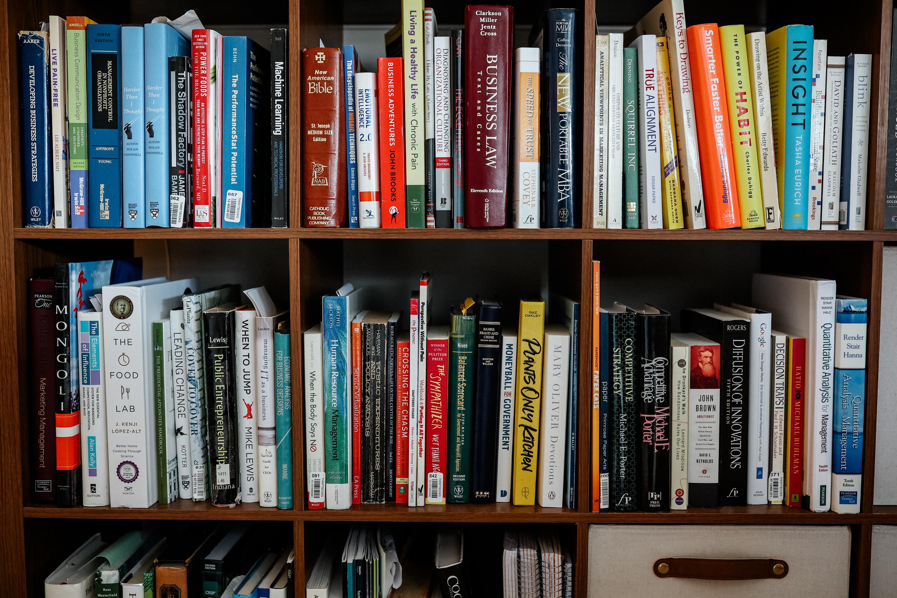 A shelf filled with a variety of books.