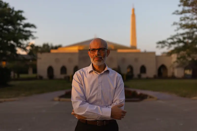 A man stands with his arms crossed.